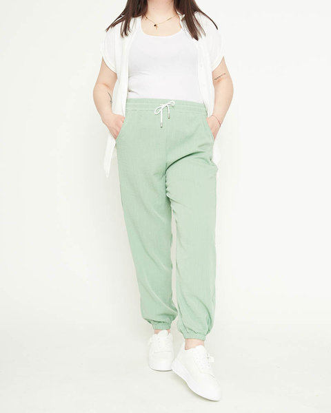 Жіночі штани з зеленої тканини - Одяг